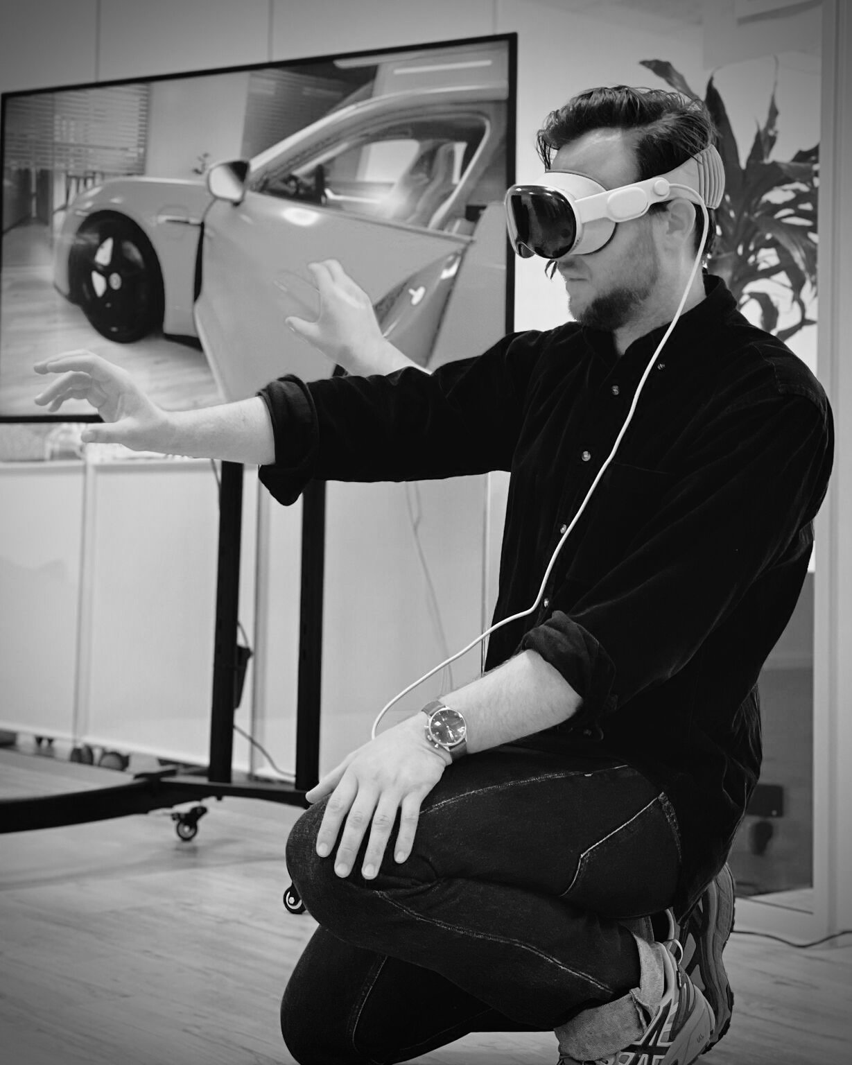 Matias wearing Apple Vision Pro beside the Porsche Taycan configurator.